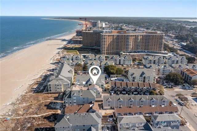 drone / aerial view with a water view and a beach view