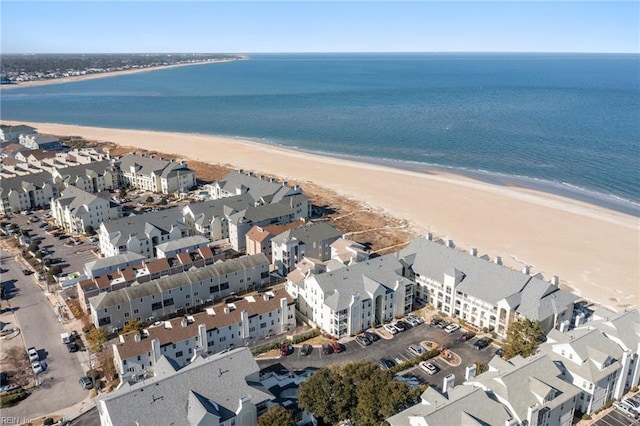 drone / aerial view featuring a beach view and a water view