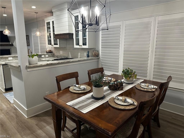 dining area featuring an inviting chandelier and dark wood-type flooring