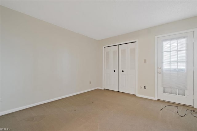 unfurnished bedroom featuring a closet and carpet flooring