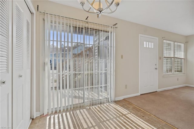 foyer entrance with carpet and a healthy amount of sunlight