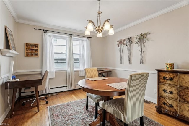 dining space featuring light wood-type flooring, an inviting chandelier, and ornamental molding