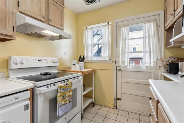 kitchen with white appliances, light brown cabinetry, and light tile patterned floors