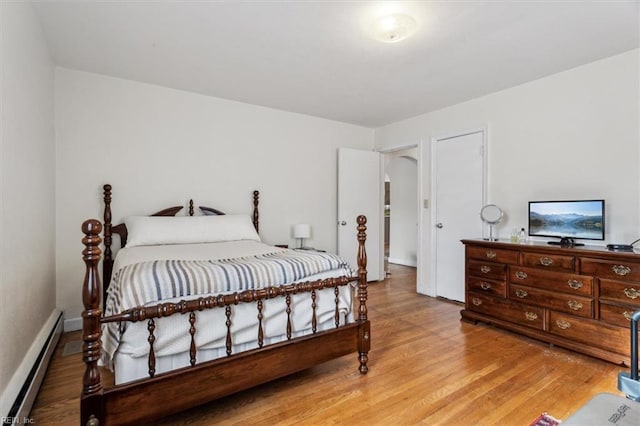 bedroom featuring a baseboard radiator and hardwood / wood-style floors