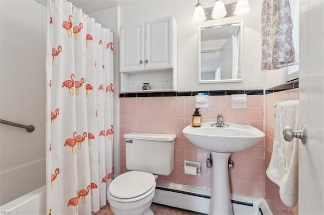 bathroom with toilet, shower / tub combo, tile walls, and baseboard heating