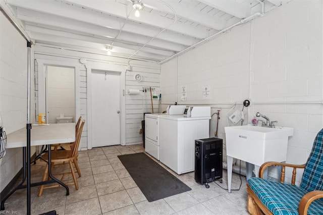 clothes washing area with sink, separate washer and dryer, and light tile patterned floors