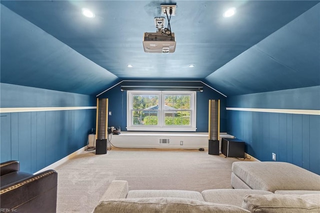 carpeted home theater room featuring lofted ceiling