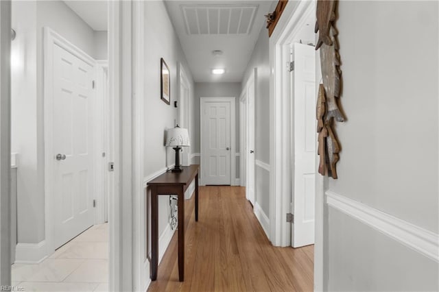 hallway with light hardwood / wood-style floors