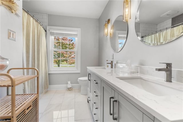 bathroom featuring toilet and vanity