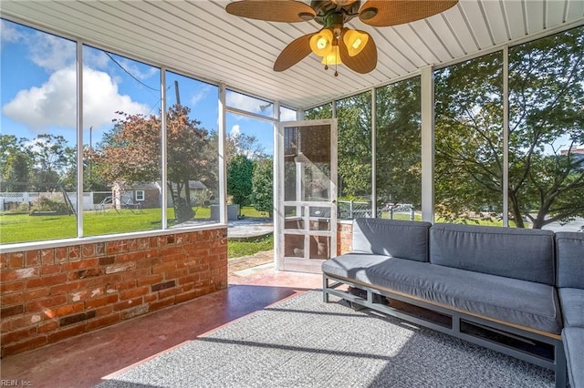 sunroom featuring ceiling fan and a wealth of natural light