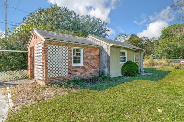 view of side of home with a yard