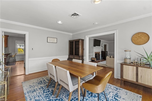 dining space featuring dark hardwood / wood-style floors and crown molding