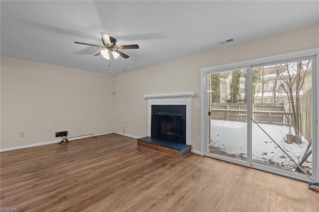 unfurnished living room with ceiling fan and hardwood / wood-style floors