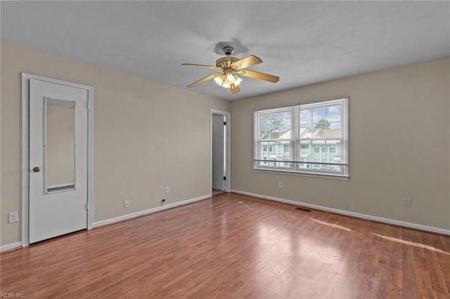 empty room featuring ceiling fan and wood-type flooring