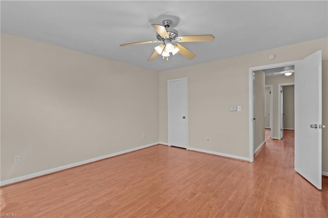 empty room featuring ceiling fan and light wood-type flooring