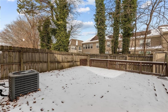 yard covered in snow featuring central AC