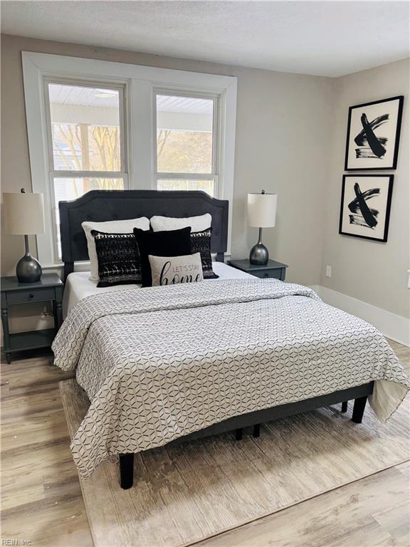 bedroom featuring hardwood / wood-style flooring and multiple windows