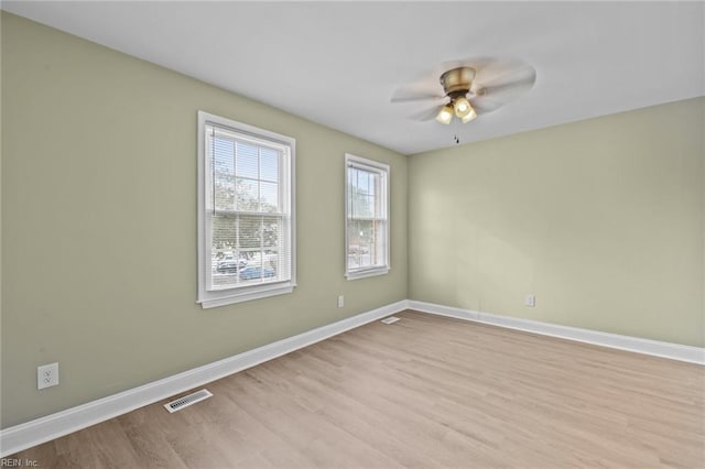 empty room featuring ceiling fan and light hardwood / wood-style flooring