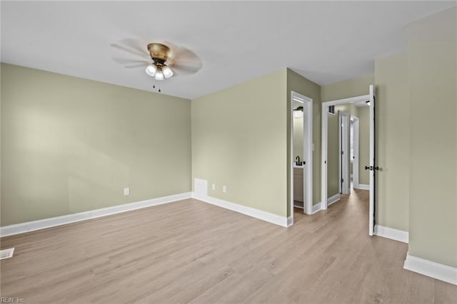 spare room featuring light hardwood / wood-style floors and ceiling fan