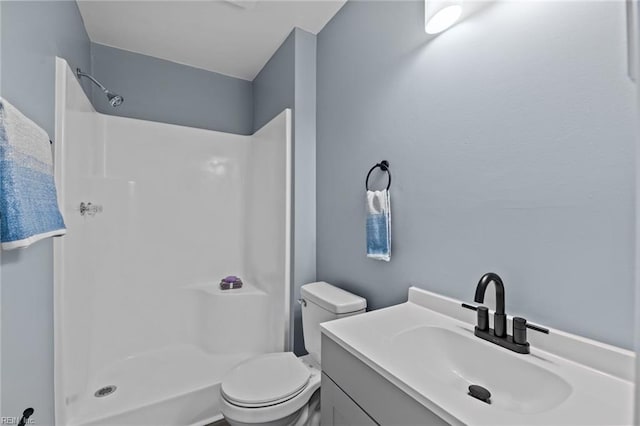 bathroom with vanity, toilet, and walk in shower