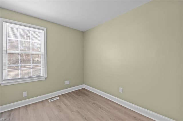 empty room with light hardwood / wood-style flooring