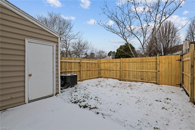 yard covered in snow featuring central AC unit