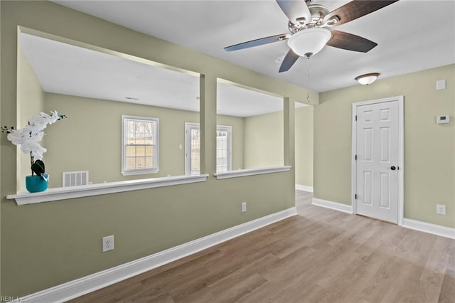 empty room with light hardwood / wood-style flooring and ceiling fan