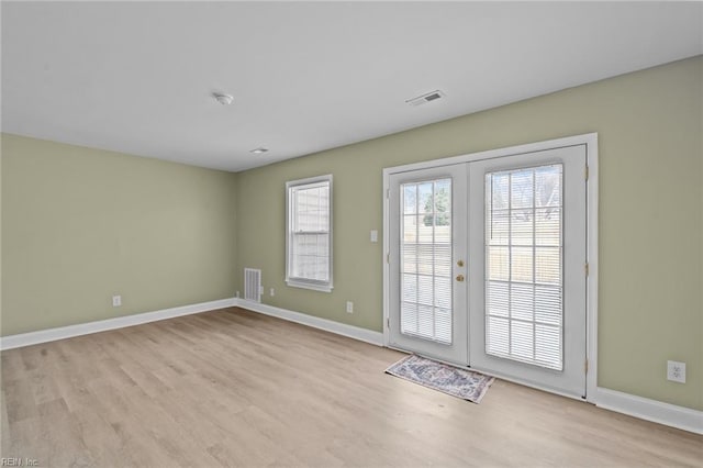 doorway featuring light wood-type flooring and french doors