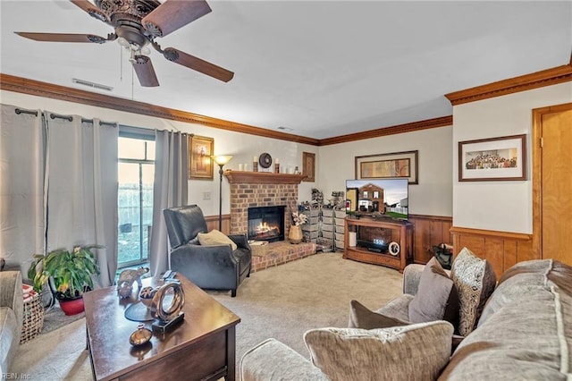 carpeted living room featuring wood walls, ornamental molding, and a fireplace