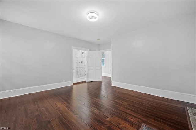 unfurnished room featuring dark wood-type flooring