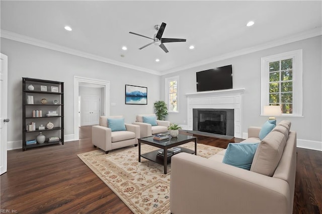 living room with plenty of natural light, dark hardwood / wood-style flooring, and ornamental molding