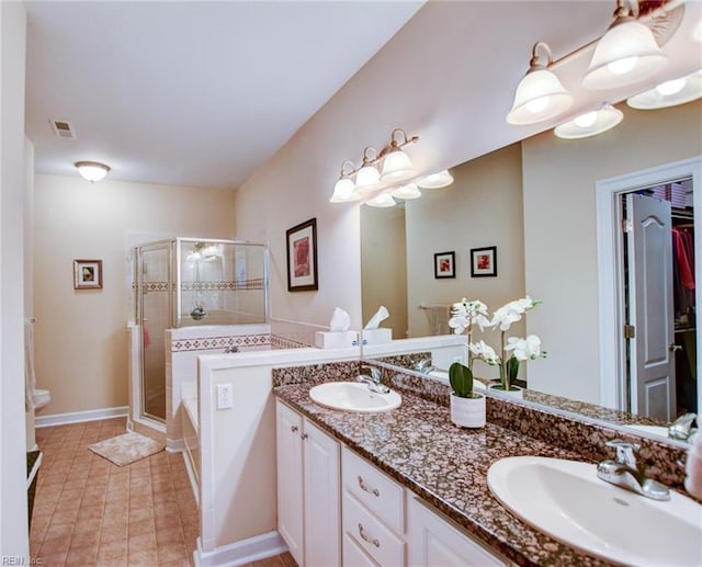 bathroom with vanity, a shower with shower door, and tile patterned floors