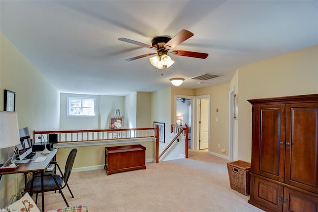 office space featuring ceiling fan and light colored carpet