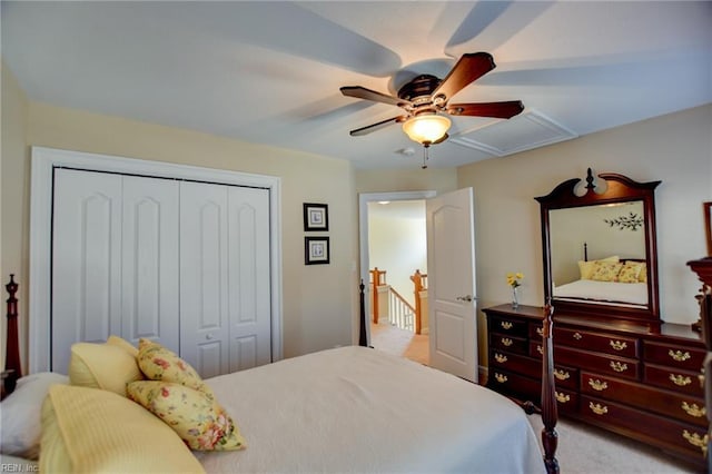 carpeted bedroom with ceiling fan and a closet