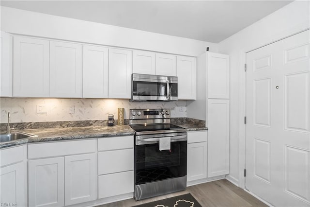 kitchen featuring sink, white cabinets, and stainless steel appliances