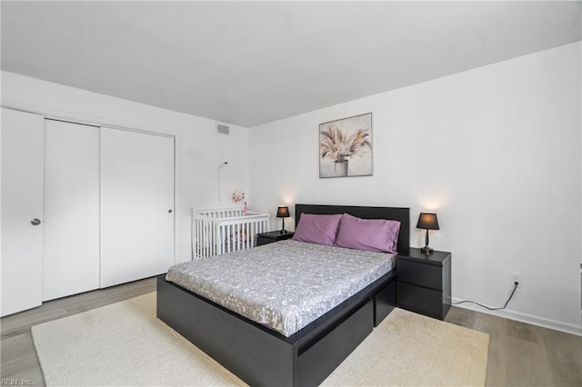 bedroom featuring wood-type flooring and a closet