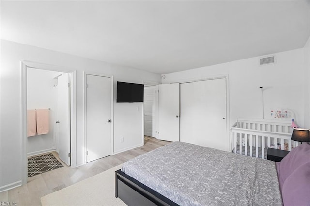 bedroom with light hardwood / wood-style flooring and a closet