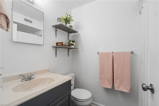 bathroom with toilet and vanity