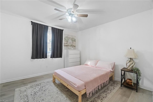 bedroom with wood-type flooring and ceiling fan