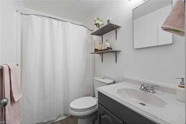 bathroom with hardwood / wood-style flooring, toilet, and vanity