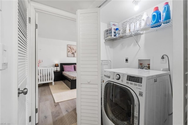 washroom featuring light hardwood / wood-style floors and washer / clothes dryer