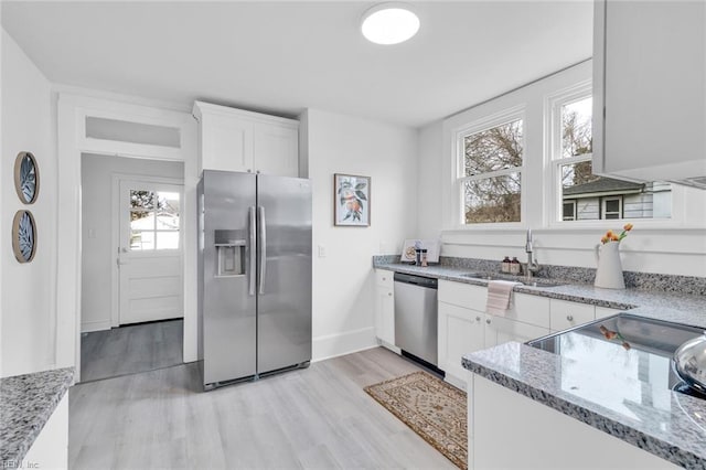 kitchen featuring sink, stainless steel appliances, light stone counters, and white cabinets