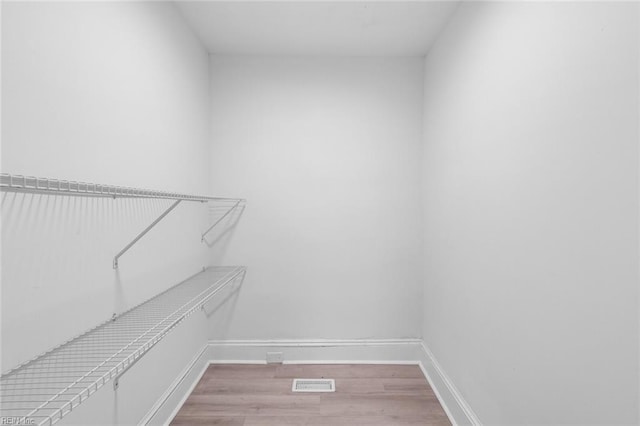 walk in closet featuring light hardwood / wood-style flooring