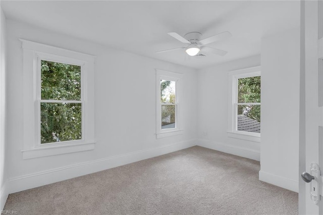 carpeted empty room featuring ceiling fan