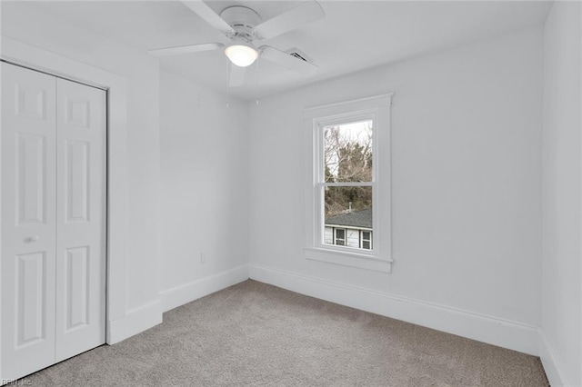 carpeted empty room with ceiling fan