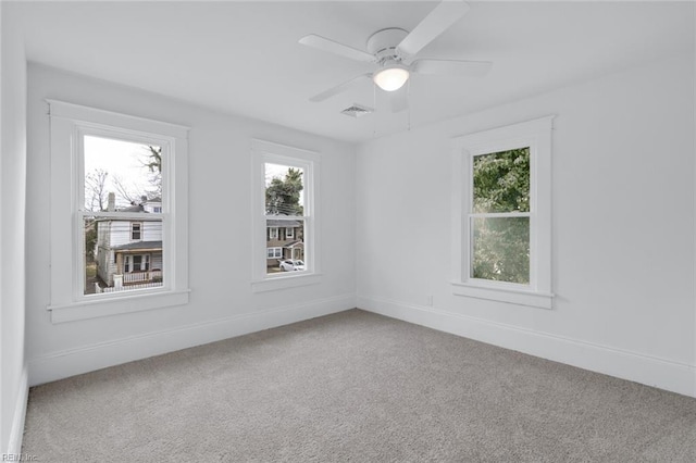 carpeted empty room featuring ceiling fan