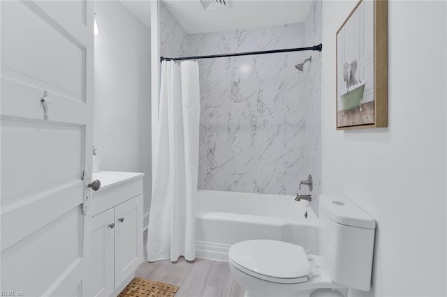 full bathroom featuring shower / bath combo with shower curtain, wood-type flooring, toilet, and vanity