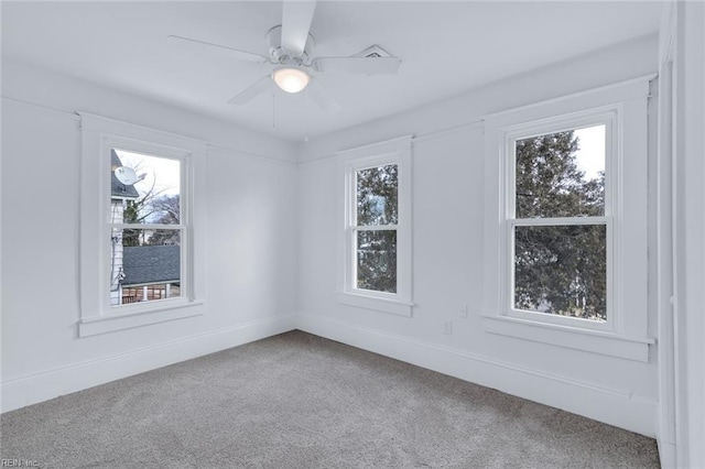 carpeted empty room featuring ceiling fan