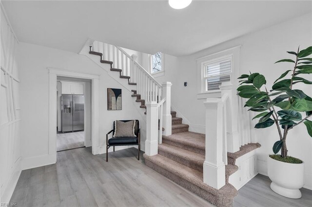 stairs with hardwood / wood-style floors