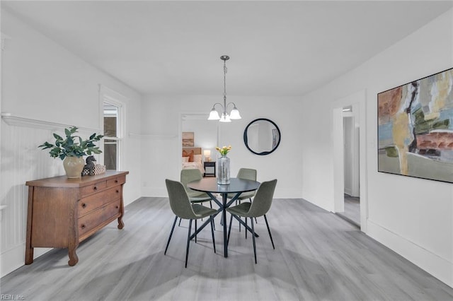 dining room featuring light hardwood / wood-style flooring and an inviting chandelier